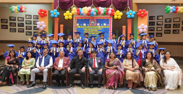 Dignitaries posing along with students during a programme.