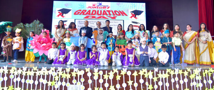 Achievers of Jodhamal Juniors posing with guests and teachers during a function.