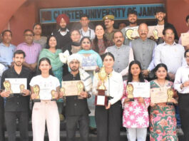 Outstanding achievers posing along with University Management.