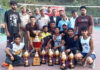 Winners of Volleyball tournament posing with police officers.