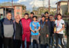 Winners of Badminton Tournament posing with senior citizens.
