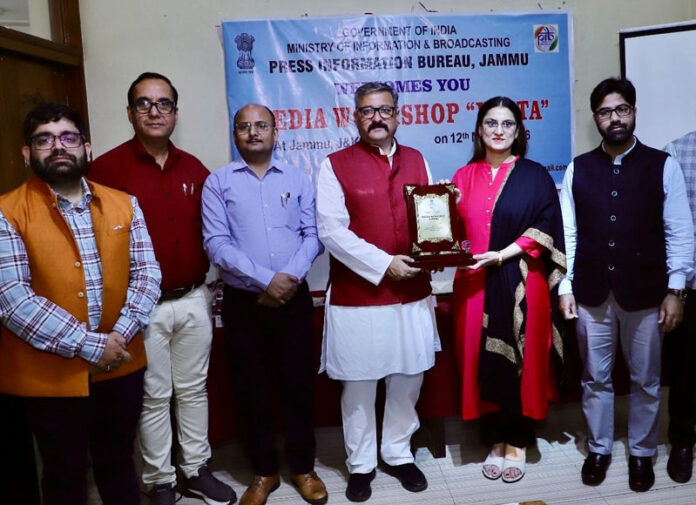 Press Club of Jammu's Vice-President Zorawar Singh Jamwal greeting Director PIB Jammu Neha Jalali with a souvenir on Thursday.