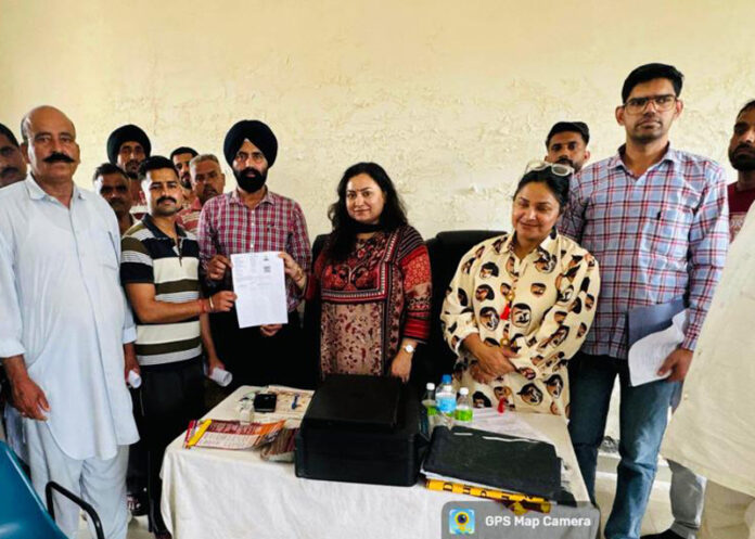 Officials posing along with others during a camp organized in R S Pura.