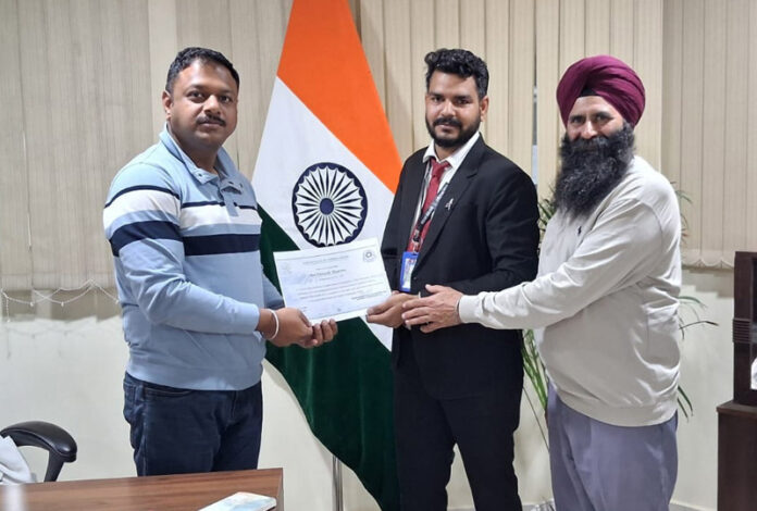 A railway ticket-checking staff member of Jammu division being honoured by SDCM Uchit Singhal in Jammu on Saturday.