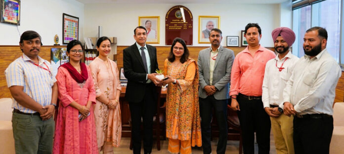 A dignitary being presented with a souvenir during a programme at AIIMS Jammu.