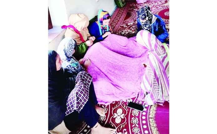 Women in village Simari at LoC in Teetwal busy in embroidery works.