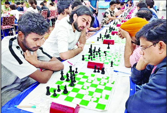 Chess players engrossed in deep thought, carefully planning their next move during the event.
