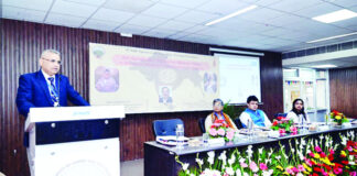 A speaker delivering address during seminar on "Sri Aurobindo's Vision for Human Unity" at CUJ.