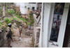 Security personnel stand guard during searches by the NIA in Poonch on Thursday.