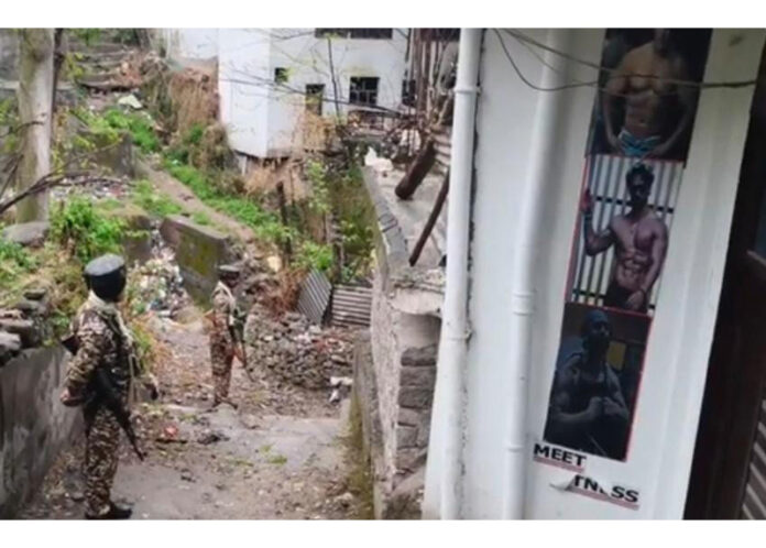 Security personnel stand guard during searches by the NIA in Poonch on Thursday.