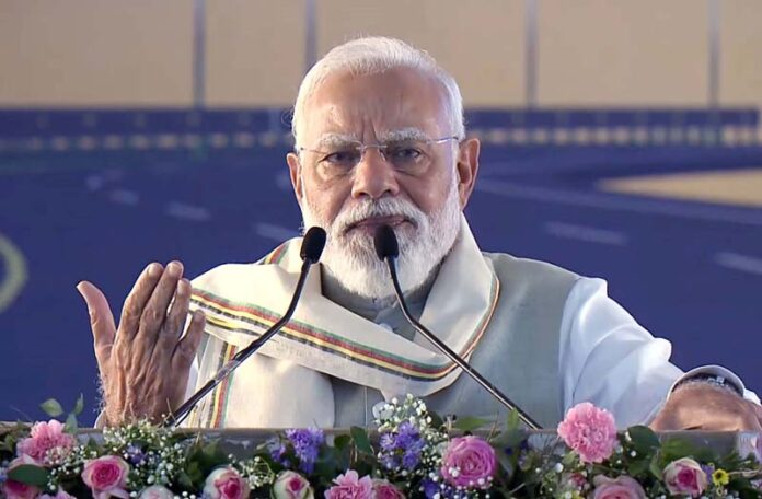 Prime Minister Narendra Modi addresses a public meeting in Silchar, Assam on Saturday. (UNI) Prime Minister Narendra Modi addresses a public meeting in Silchar, Assam on Saturday. (UNI)