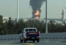 After a drone attack, smoke rises from a fire at Dubai International Airport on Monday.