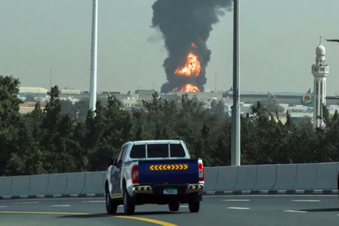 After a drone attack, smoke rises from a fire at Dubai International Airport on Monday.