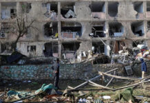 Israeli security forces and rescue teams work at the site struck by an Iranian missile in Arad, southern Israel on Sunday.