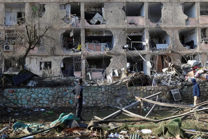 Israeli security forces and rescue teams work at the site struck by an Iranian missile in Arad, southern Israel on Sunday.