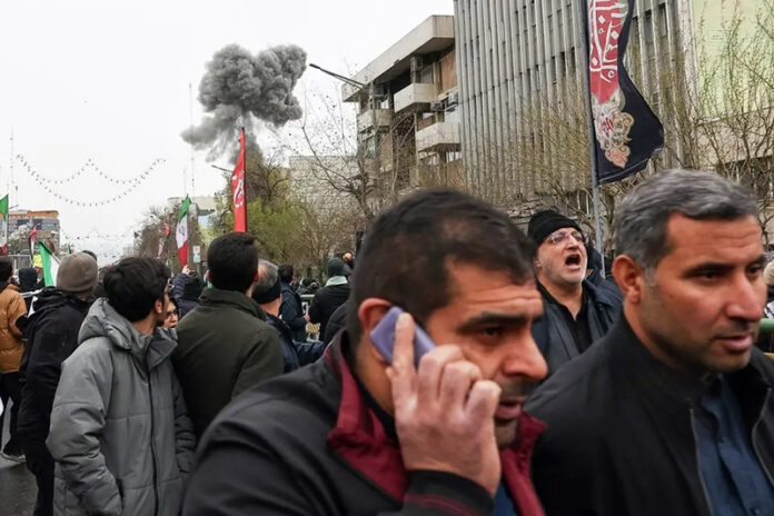 Smoke from an explosion rises behind demonstrators attending the annual anti-Israeli Quds Day rally in support of Palestinians in Tehran, Ian on Friday.