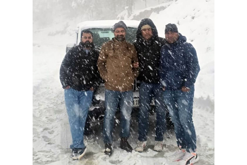 Local tourists enjoying snowfall on Mughal Road in Poonch.