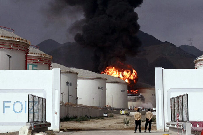 Fire and smoke rise in the Fujairah oil industry zone, caused by debris after interception of a drone by air defenses in UAE on Thursday.