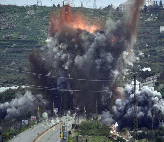 Smoke and flames rise from an Israeli airstrike that hit the Qasmiyeh Bridge near the coastal city of Tyre, Lebanon