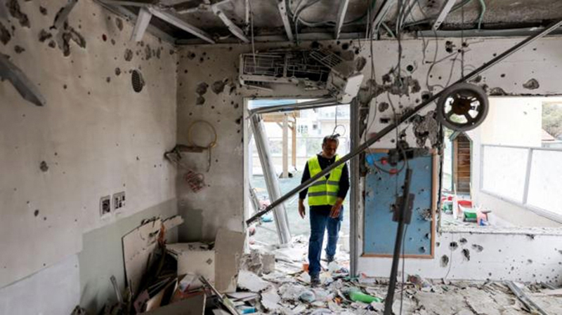 A person inspects the damage inside a kindergarten, following a barrage of missiles launches from Iran, in Rishon Lezion, Israel, on Saturday.