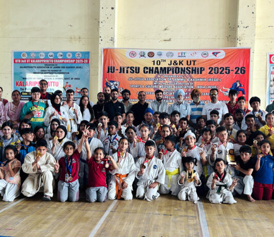 Athletes posing along with medals during closing ceremony.