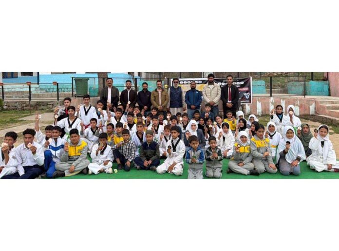 Winners and participants of District Ramban Taekwondo Championship posing for a group photograph.