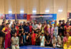 Wushu athletes posing along with dignitaries during a programme.