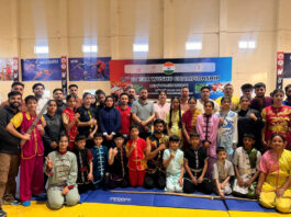 Wushu athletes posing along with dignitaries during a programme.