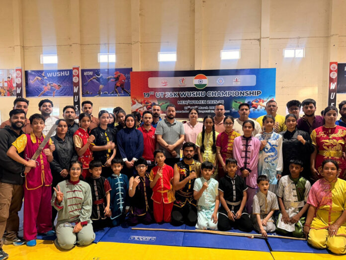 Wushu athletes posing along with dignitaries during a programme.