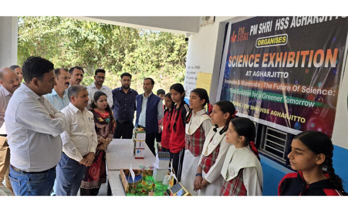 Dignitaries inspecting models during science exhibition.