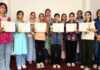Participants posing along with certificates during a programme.