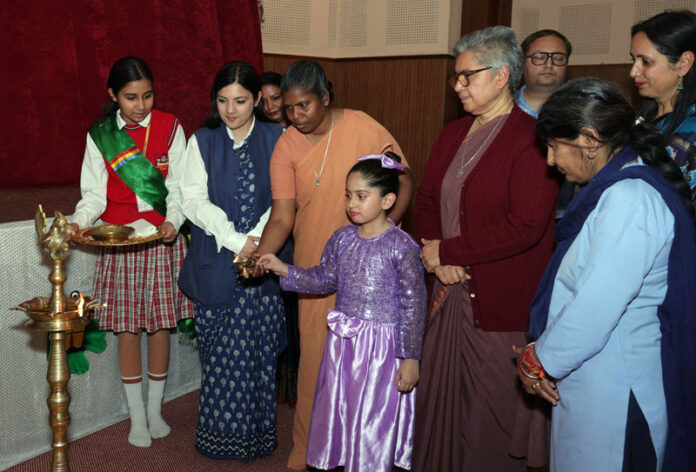 MLA Nagrota Devyani Rana lighting lamp during a programme.