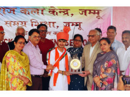 Dignitaries presenting trophy to a participant during a programme.