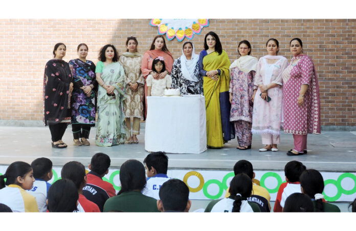 School management and staff posing during the programme.