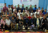 Medal winners posing for group photograph during prize distribution ceremony.