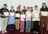 Participants posing along with certificates.