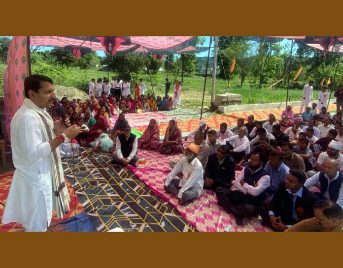 R S Pathania addressing gathering during observance of Guru Nabha Das Ji Jayanti celebrations at village Plaiter in Majalta.