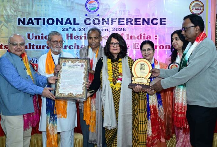 Dignitaries giving Dr. S.R Verma Memorial Award to Dr. Sonia Jasrotia during an event at Gwalior in Madhya Pradesh.