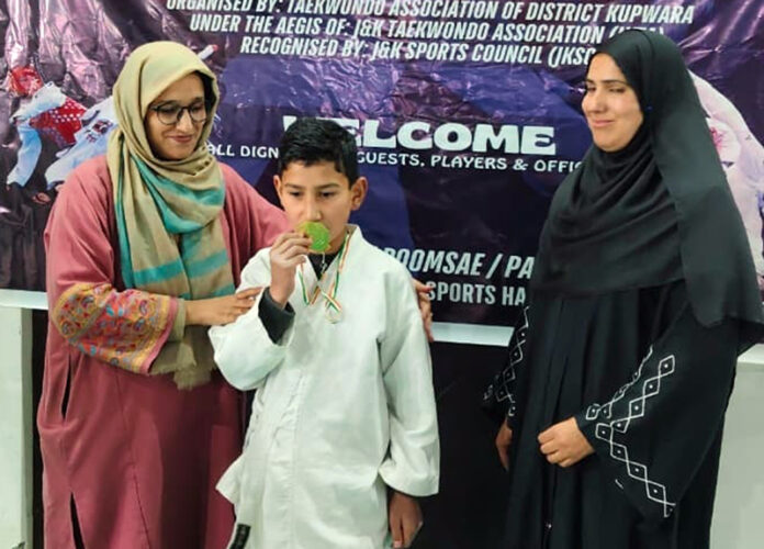 Dignitary awards medal to winner at district championship.