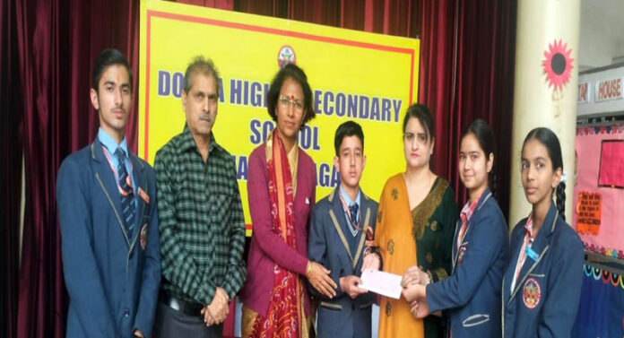 Students of Dogra Higher Secondary School presenting cheque to representatives of Zila Sainik Board.