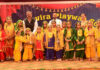 Young students posing along with dignitary.