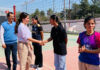 Dignitary interacting with players during sports day event.