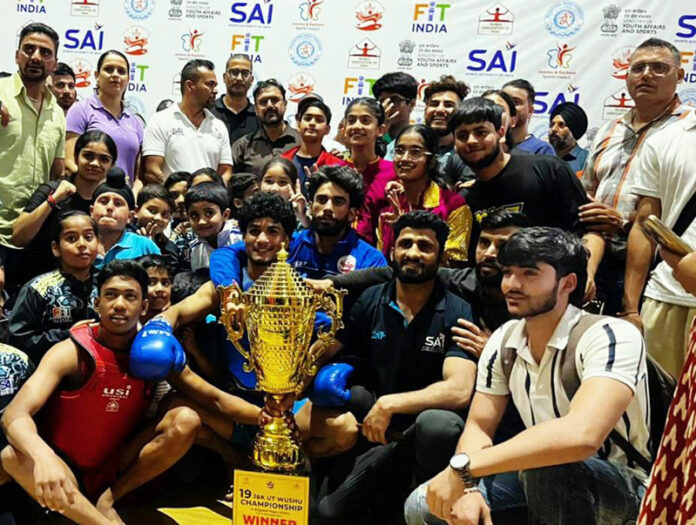 Winning team posing along with trophy during programme.