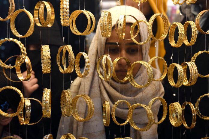 A girl making choice of bangles in a Srinagar market on Thursday. -Excelsior/Shakeel
