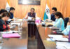 Div Com chairing a meeting on Tuesday.