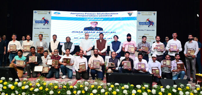 CM Omar Abdullah posing for group photograph with linemen after felicitating them at Jammu on Saturday.