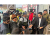 Railway staff conducting ticket checking operation.