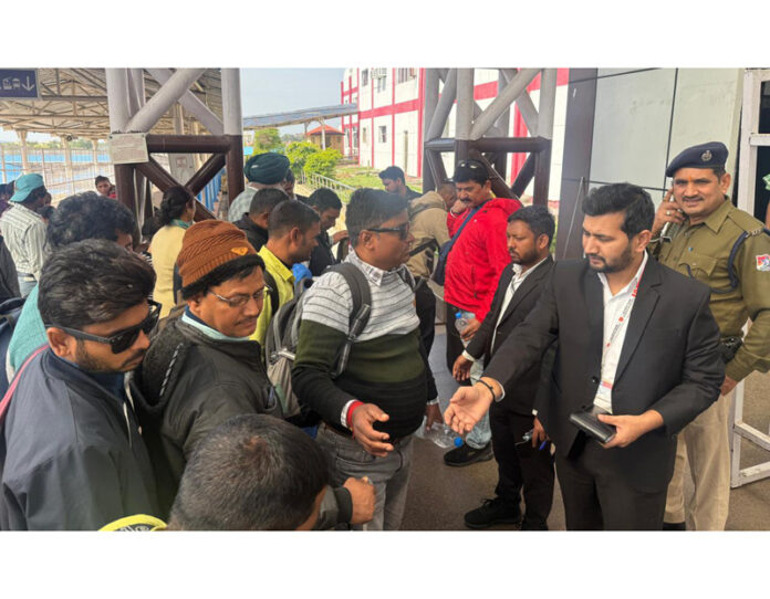 Railway staff conducting ticket checking operation.