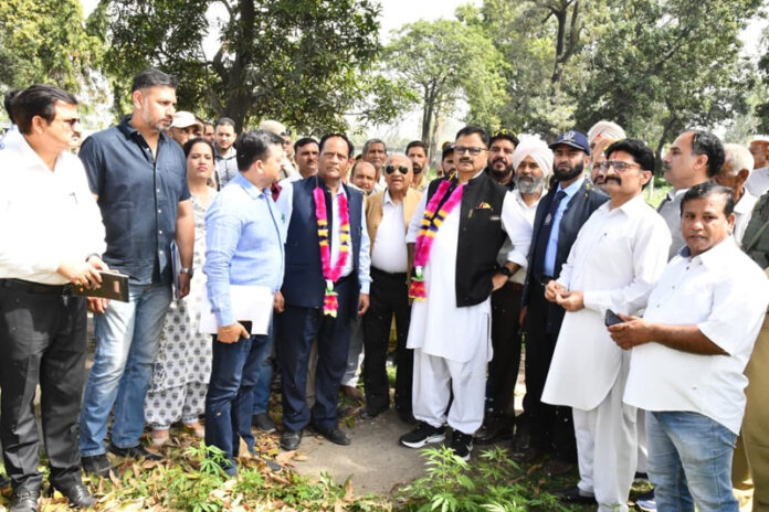 Minister Javed Rana inspecting desilting of canals on Saturday.