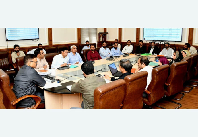 Minister Javed Rana chairing a meeting at Jammu on Thursday.